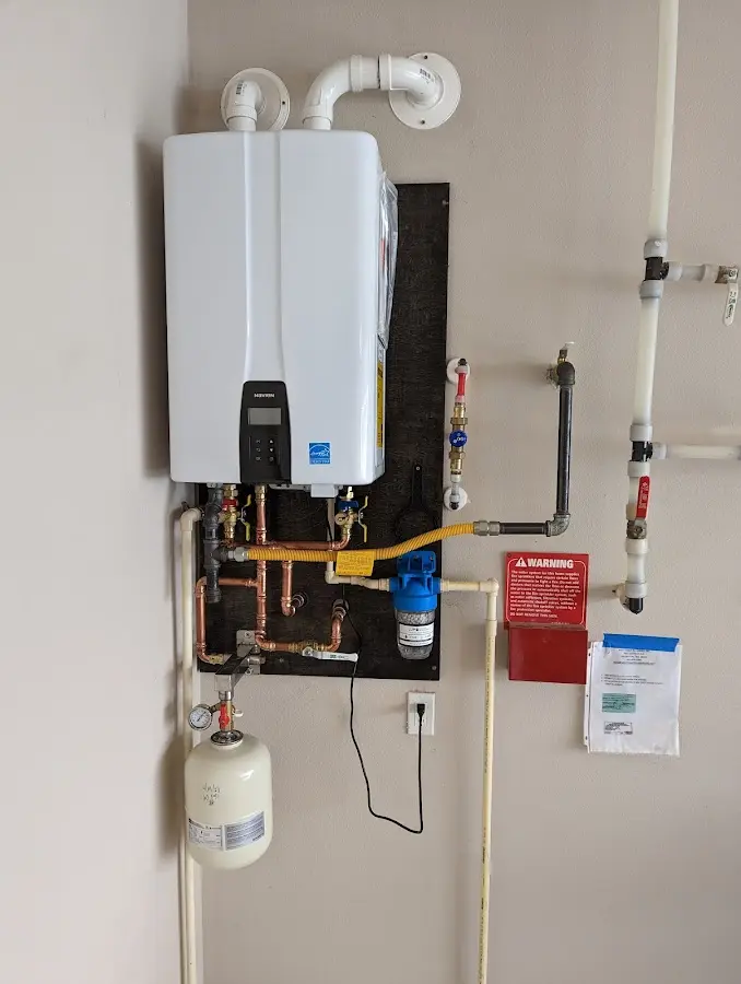 Professional plumber installing copper piping in a Arlington home